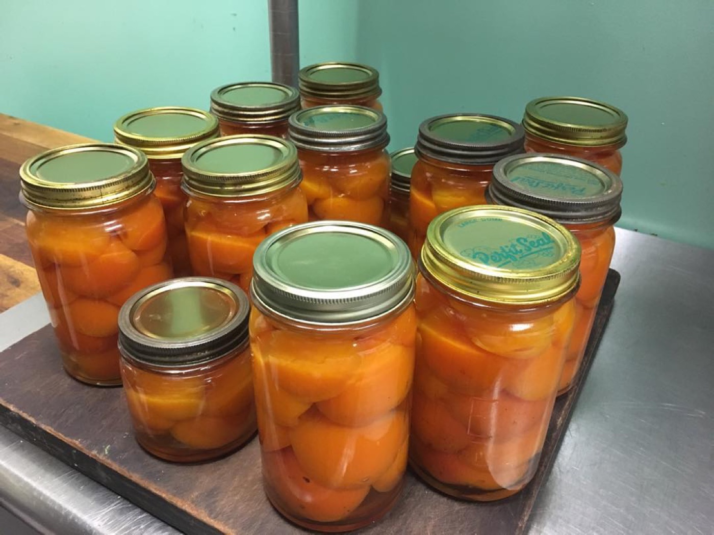 Jars of bottled apricots on a tray