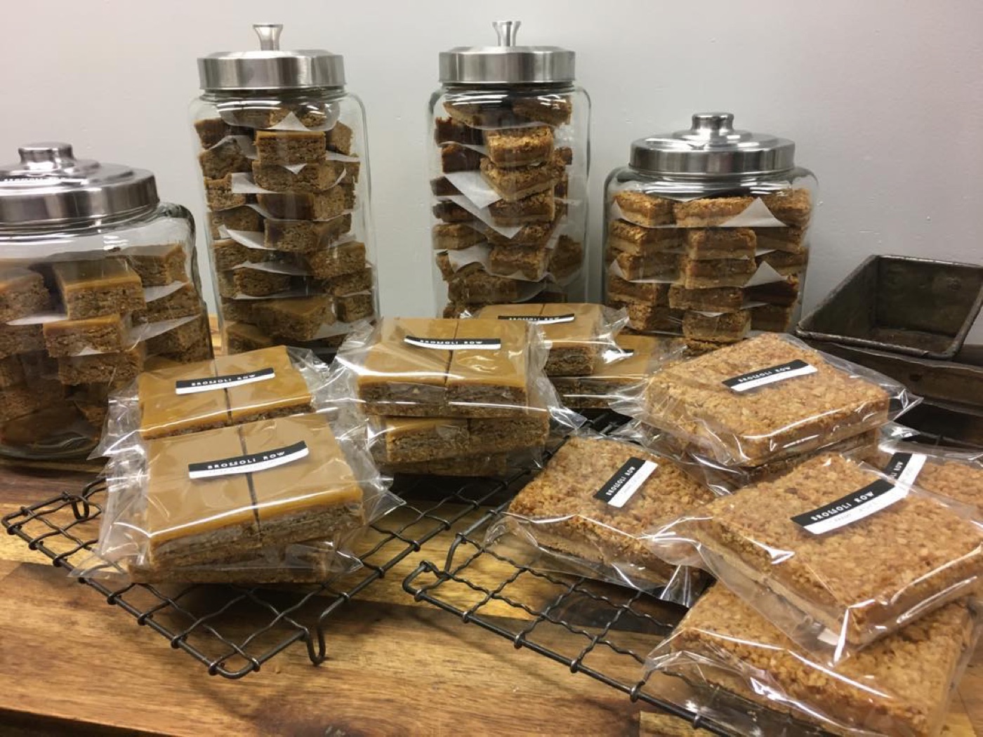 Glass jars of slices and wrapped slices cooling on a rack