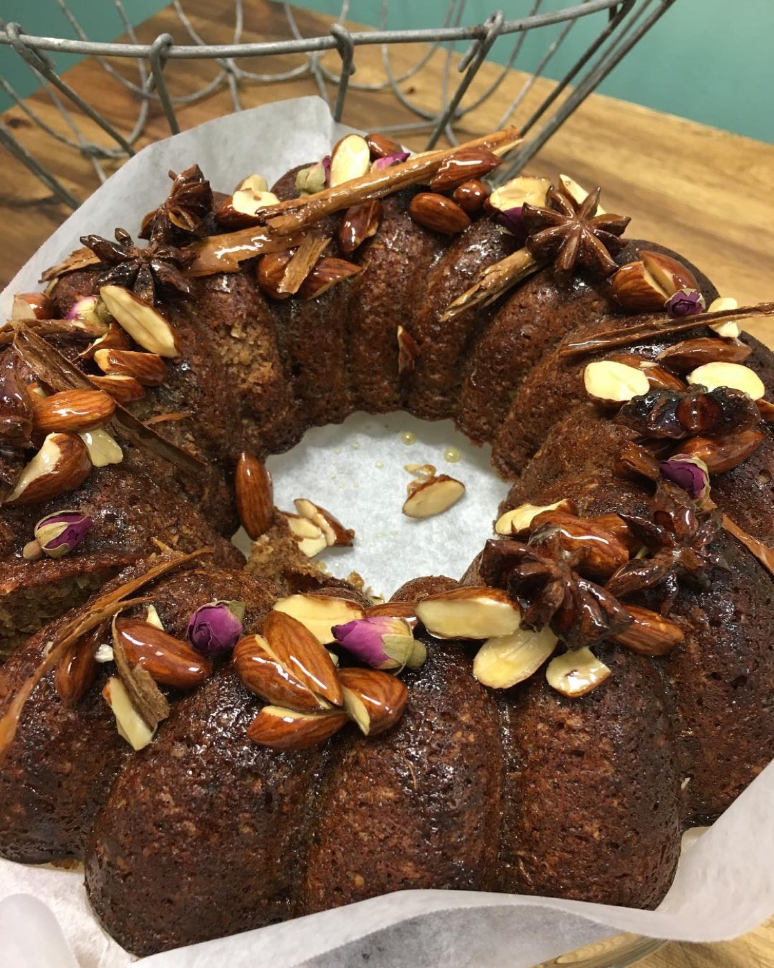 Spiced cake topped with almonds, star anise and rose petals